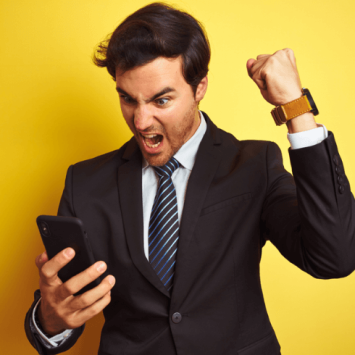 Man in suit shouting at smartphone, representing parent communication