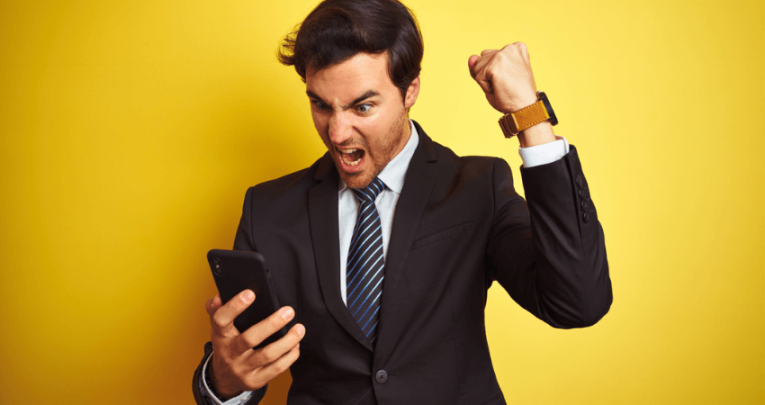 Man in suit shouting at smartphone, representing parent communication