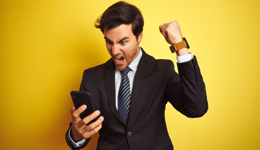 Man in suit shouting at smartphone, representing parent communication