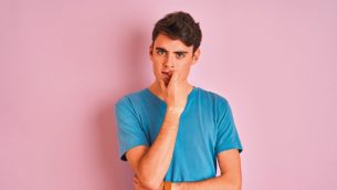 Isolated photo of a teenage boy staring impassively at the camera