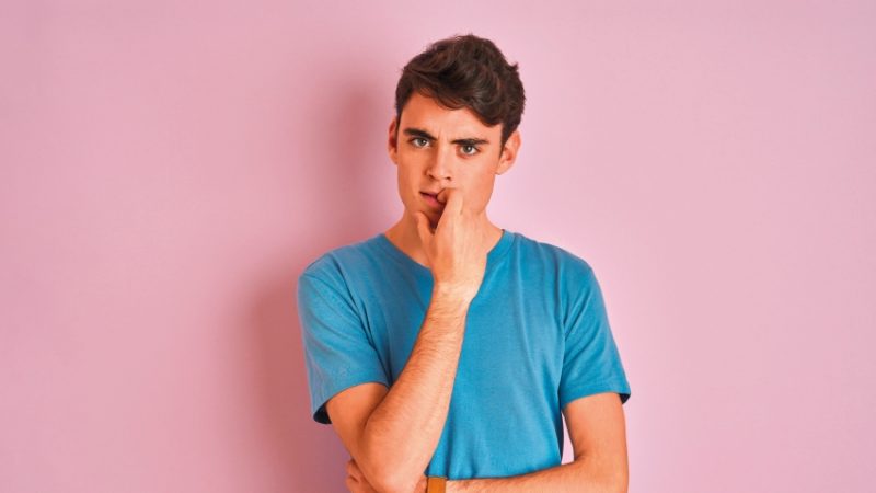 Isolated photo of a teenage boy staring impassively at the camera