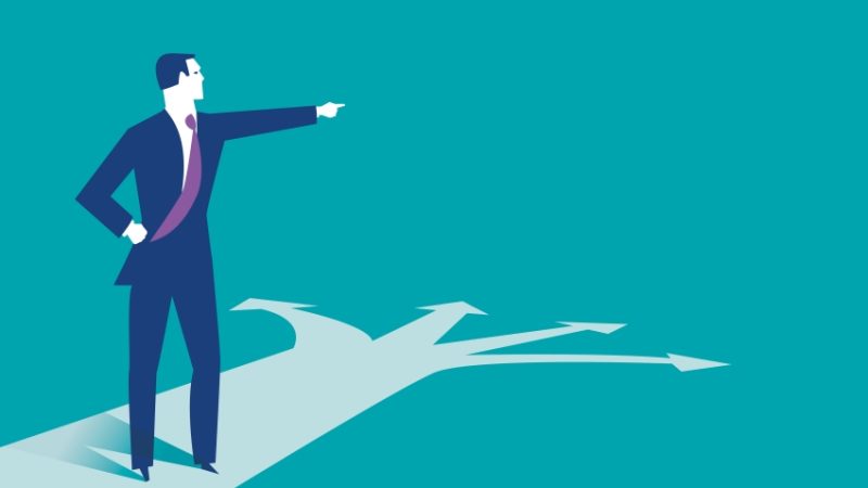 Abstract illustration of besuited figure choosing between four possible directions