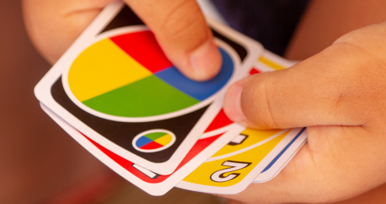 Close-up of a child playing a card game, representing starting the school day