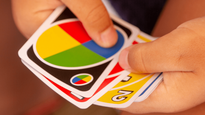 Close-up of a child playing a card game, representing starting the school day