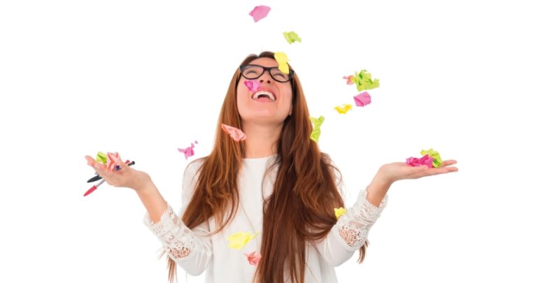 Photo of teenage girl throwing Post-it notes, representing GCSE revision