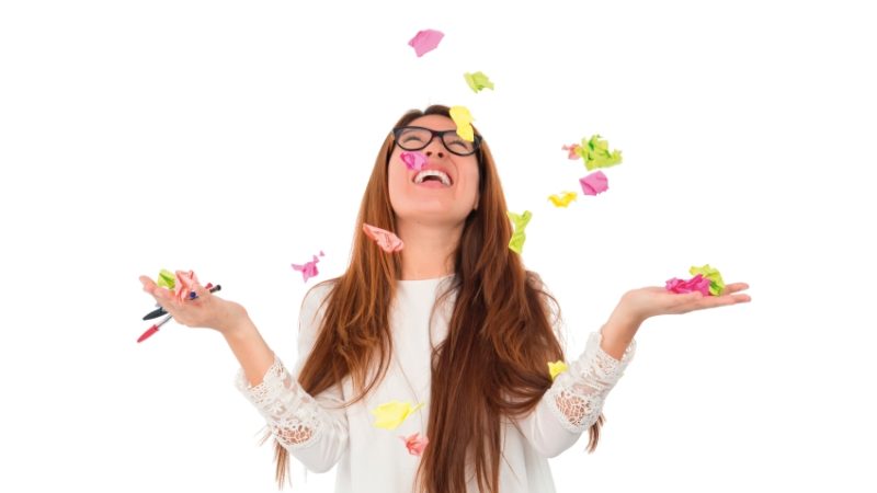 Photo of teenage girl throwing Post-it notes, representing GCSE revision