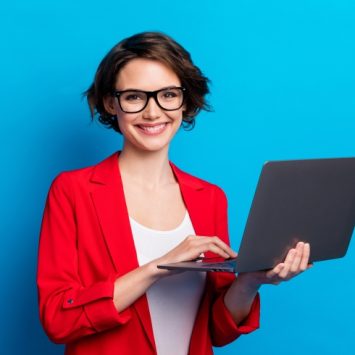 Photo of smiling businesswoman holding a laptop, representing teacher CPD