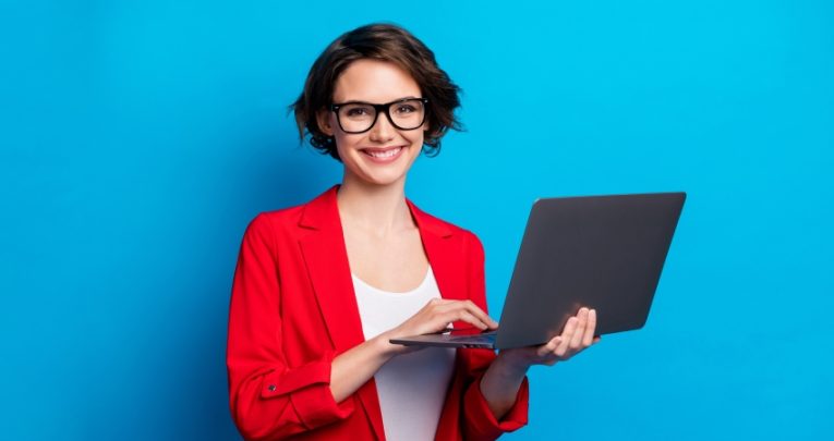 Photo of smiling businesswoman holding a laptop, representing teacher CPD
