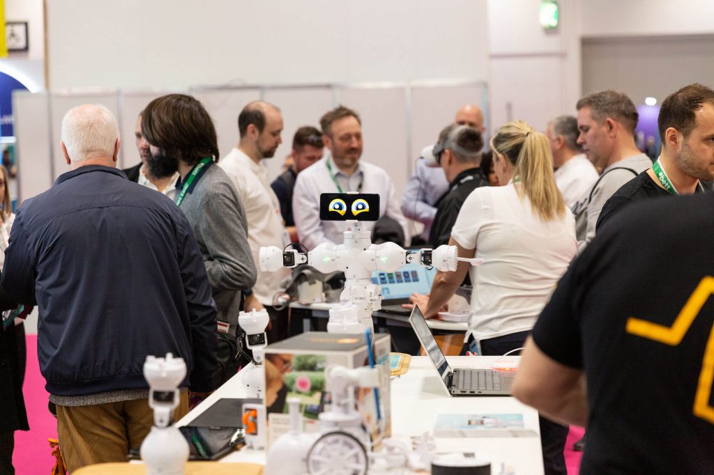 Robot at Bett show surrounded by people