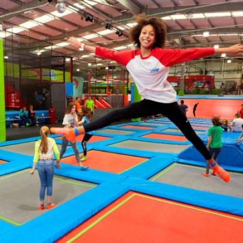 A student jumping on a trampoline at an AirHop park