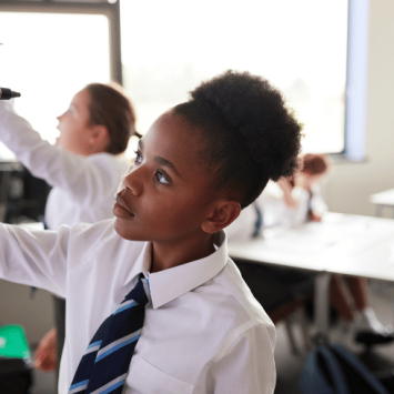 Teenager writing on smart board