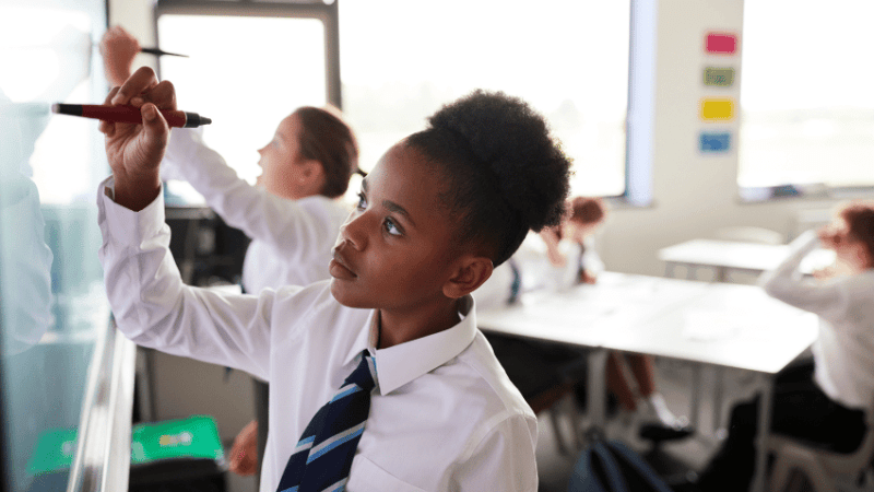 Teenager writing on smart board