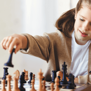 Young white girl playing chess