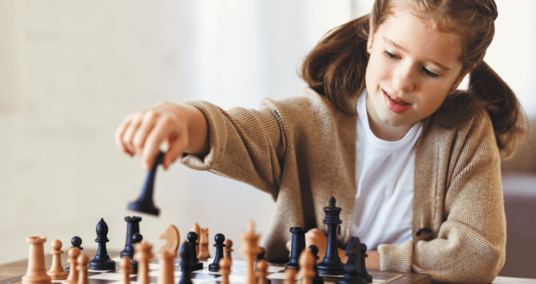 Young white girl playing chess