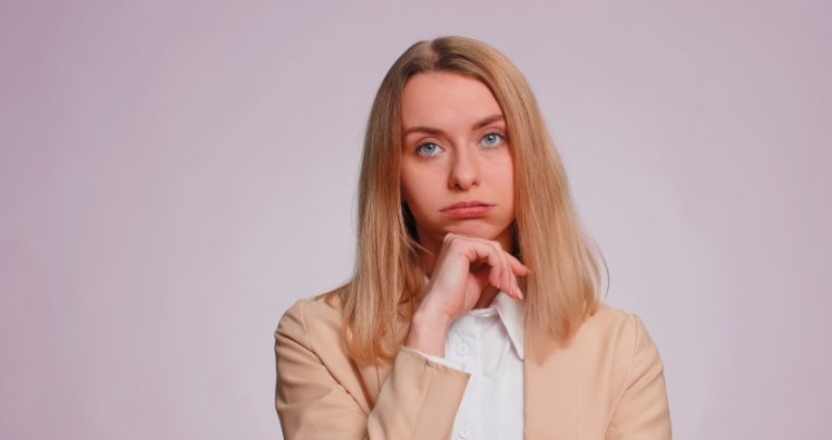 Photo of tired-looking woman, representing teacher retention