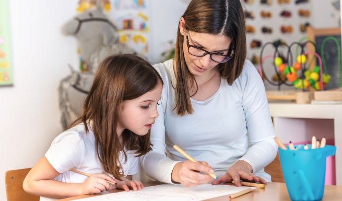 Teacher and child, representing positive behaviour support