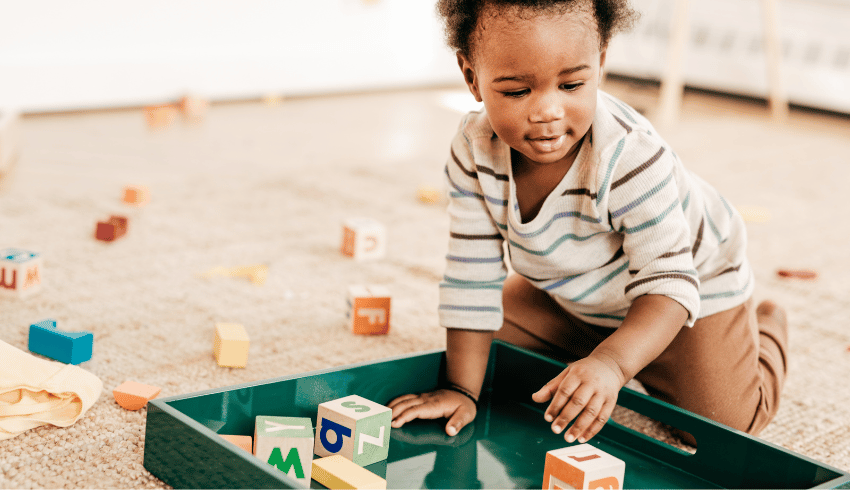 Toddler with toy blocks, representing behaviour management in Early Years