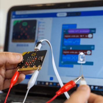 Child holding a BBC micro:bit