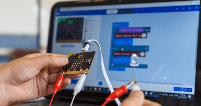 Child holding a BBC micro:bit