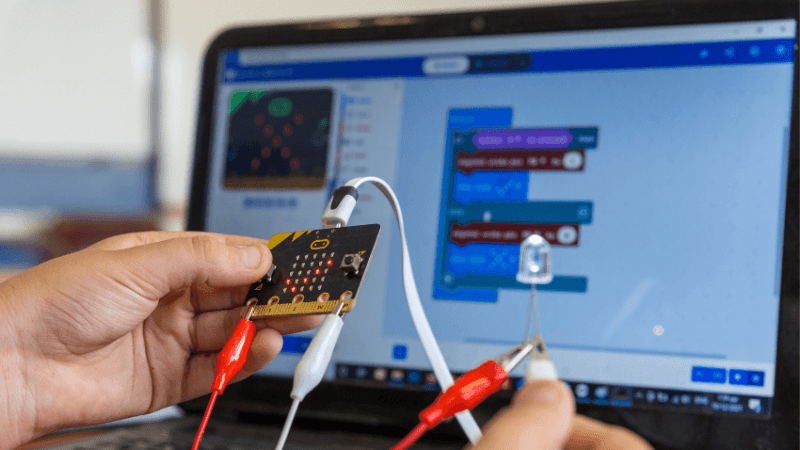 Child holding a BBC micro:bit