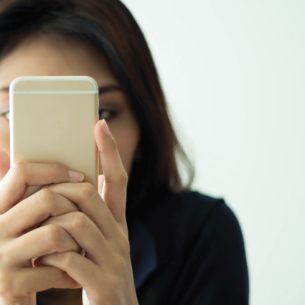Photo of woman using a smartphone with her face conceal to illustrate notion of parental complaints