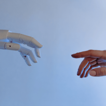 Human hand and robot hand reaching out to each other, representing AI in education