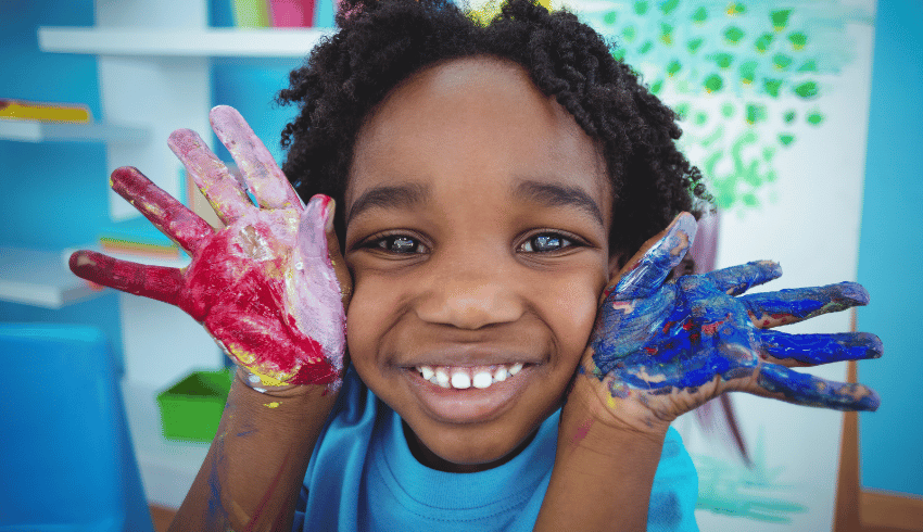 Little boy with painted hands, representing KS1 art ideas