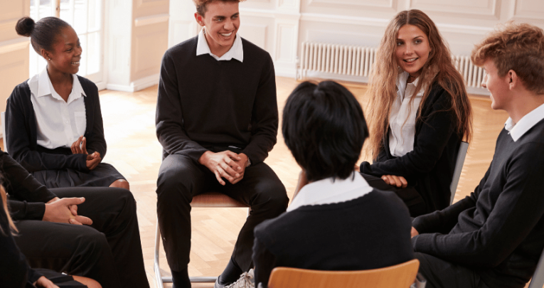 Teenagers in school uniform chatting, representing learning gap