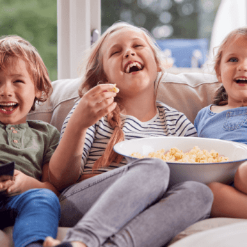 Children watching TV, representing the benefits of reading subtitles