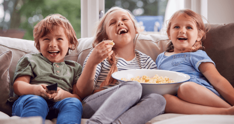 Children watching TV, representing the benefits of reading subtitles