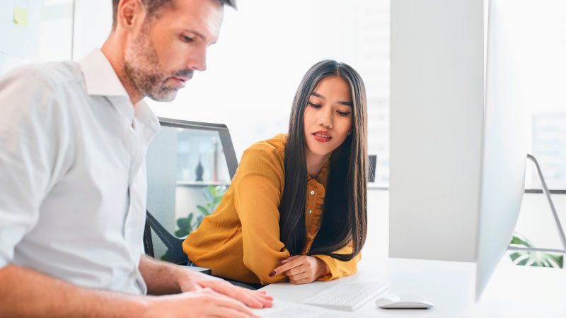 Photo of professional colleagues conversing in an office space