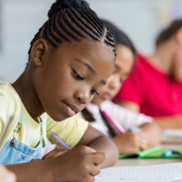 Three children writing