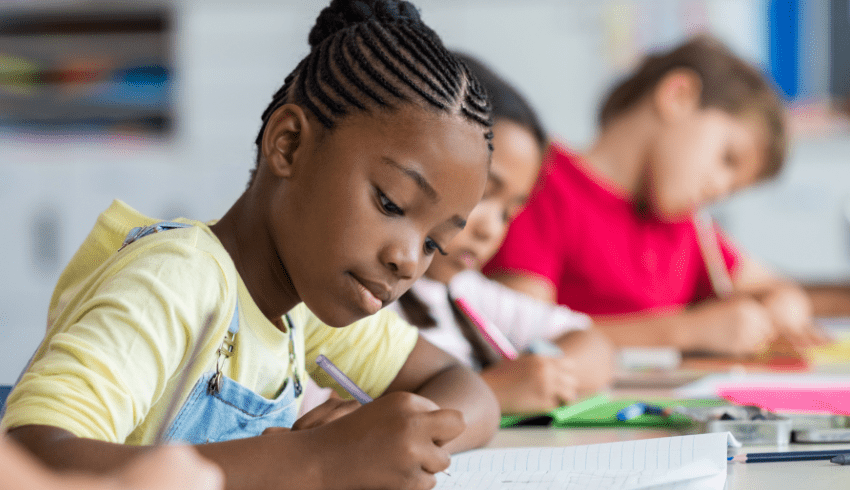 Three children writing