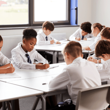 Secondary school students working at desks, representing Bloom's Taxonomy