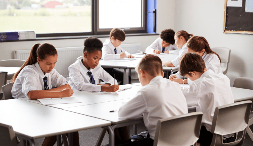 Secondary school students working at desks, representing Bloom's Taxonomy