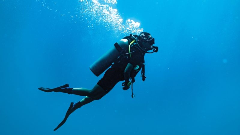 Photo of SCUBA diver to convey notions of diving below the surface