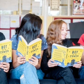 A group of school children reading books