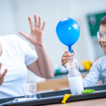 Teacher and pupil doing experiential learning with science experiment