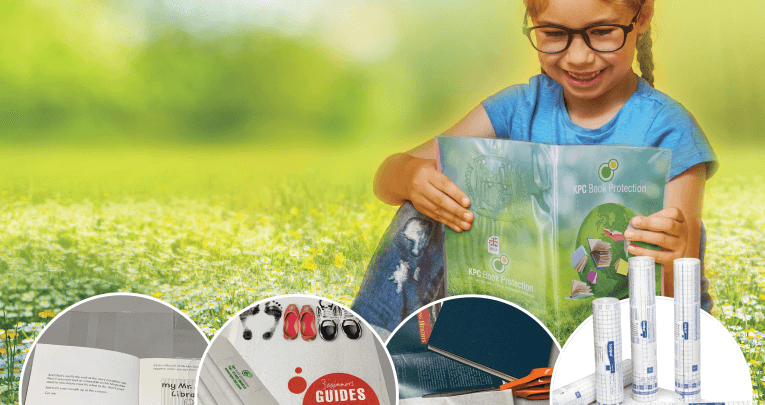 A child sitting in a field reading a book