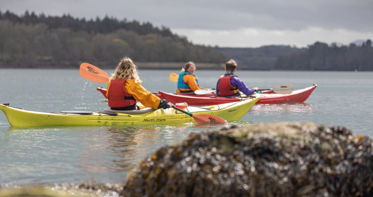 A group of secondary school students kayaking in a lake
