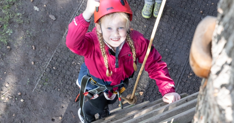 A school girl enjoying a climbing activity on a Conway Centres residential