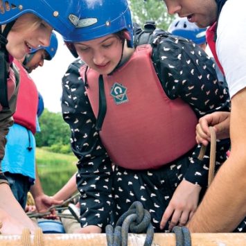 A group of secondary school students building at raft on a Kingswood residential