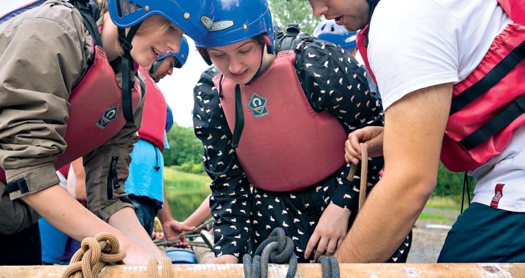A group of secondary school students building at raft on a Kingswood residential