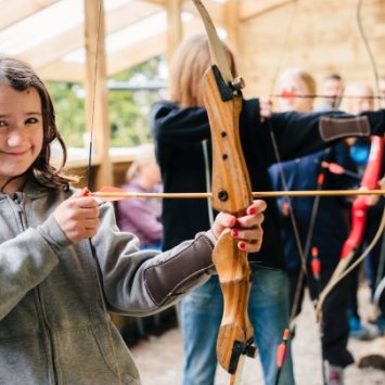 A school trying archery at Mendip Activity Centre