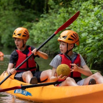 Two schoolboys in a kayak