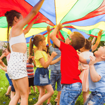 Children playing with parachute, representing HAF programme
