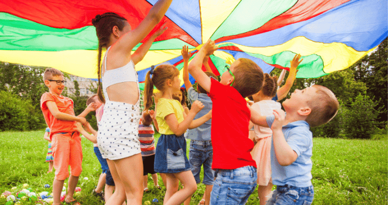 Children playing with parachute, representing HAF programme