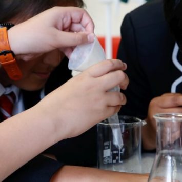 Secondary school students conducting an experiment