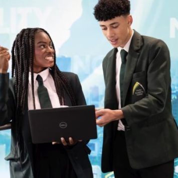 Two secondary school students looking at a laptop