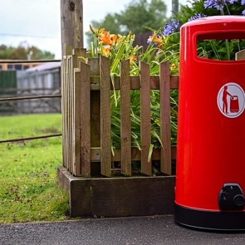 A red litter bin